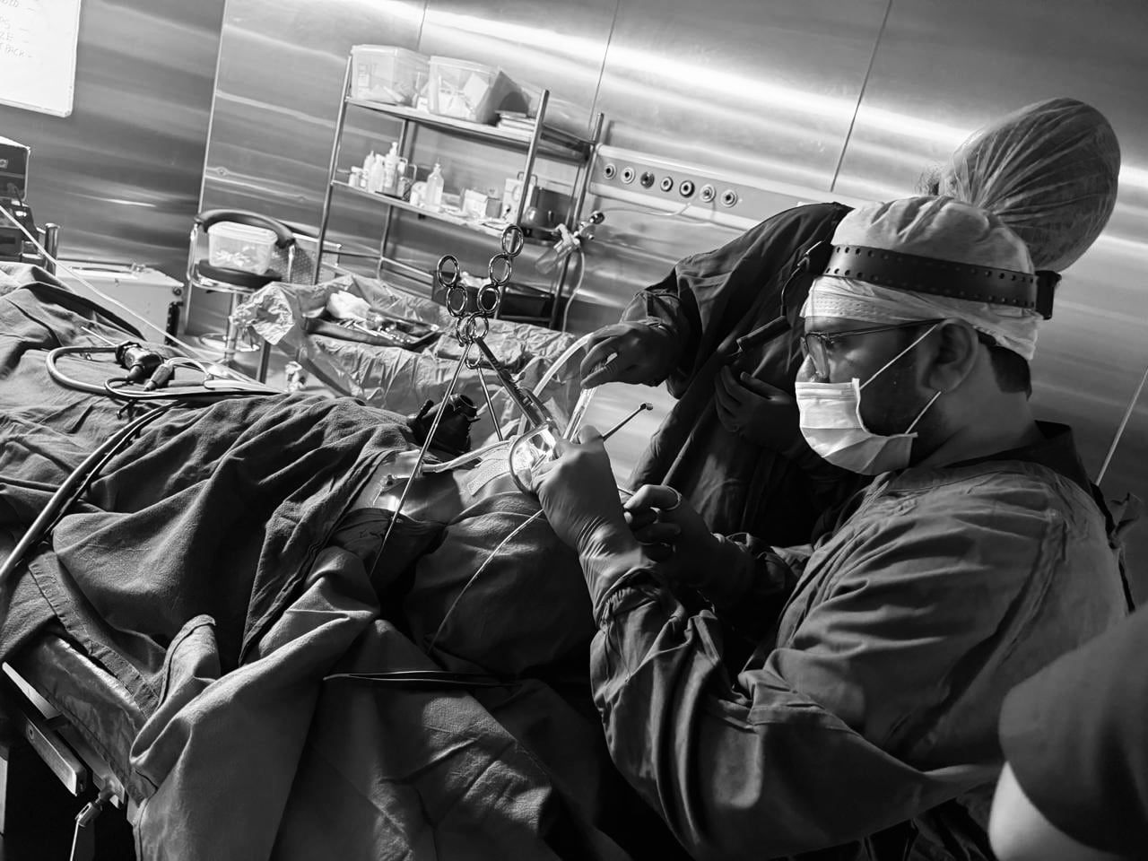 Dr. Santosh Kumar Gunapu operating, surgical headlight on