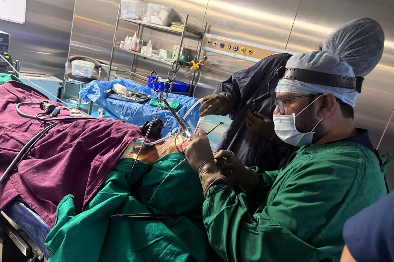 Reference: Dr. Santosh operating, surgical headlight on